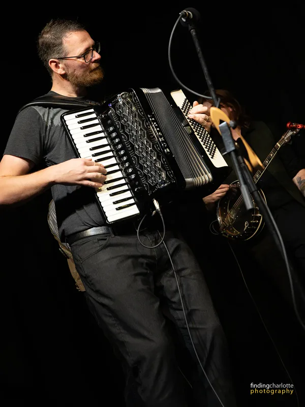 Craig Frew playing the accordion on stage